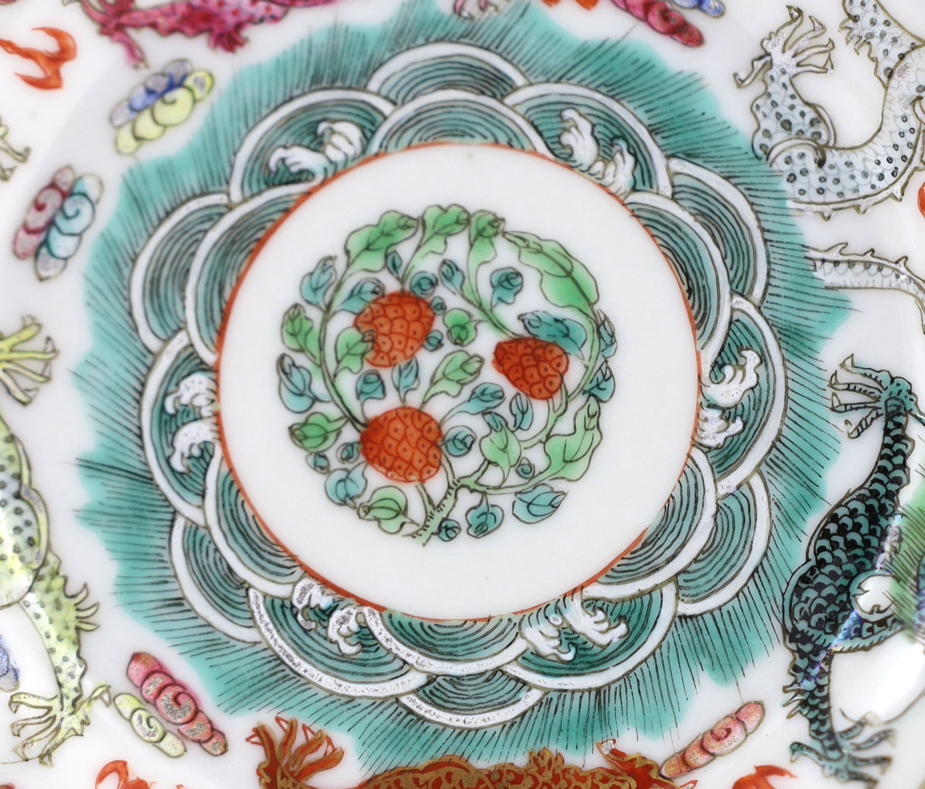 A Chinese famille rose fencai ‘dragon’ saucer dish, Jiaqing four character seal mark, 19th century, 14.6cm diameter